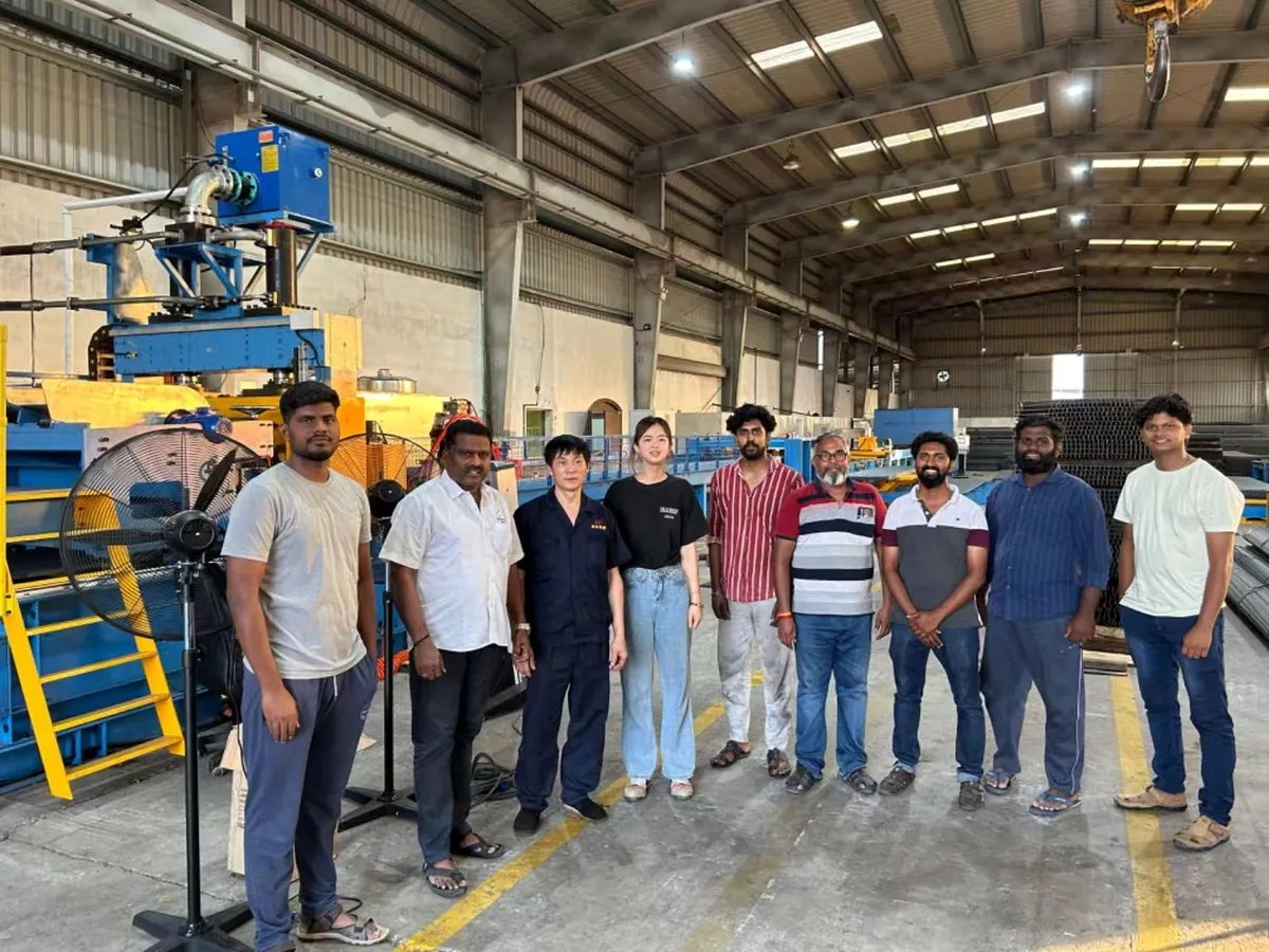 Xinzhou team with an overseas customer team beside an installed production line