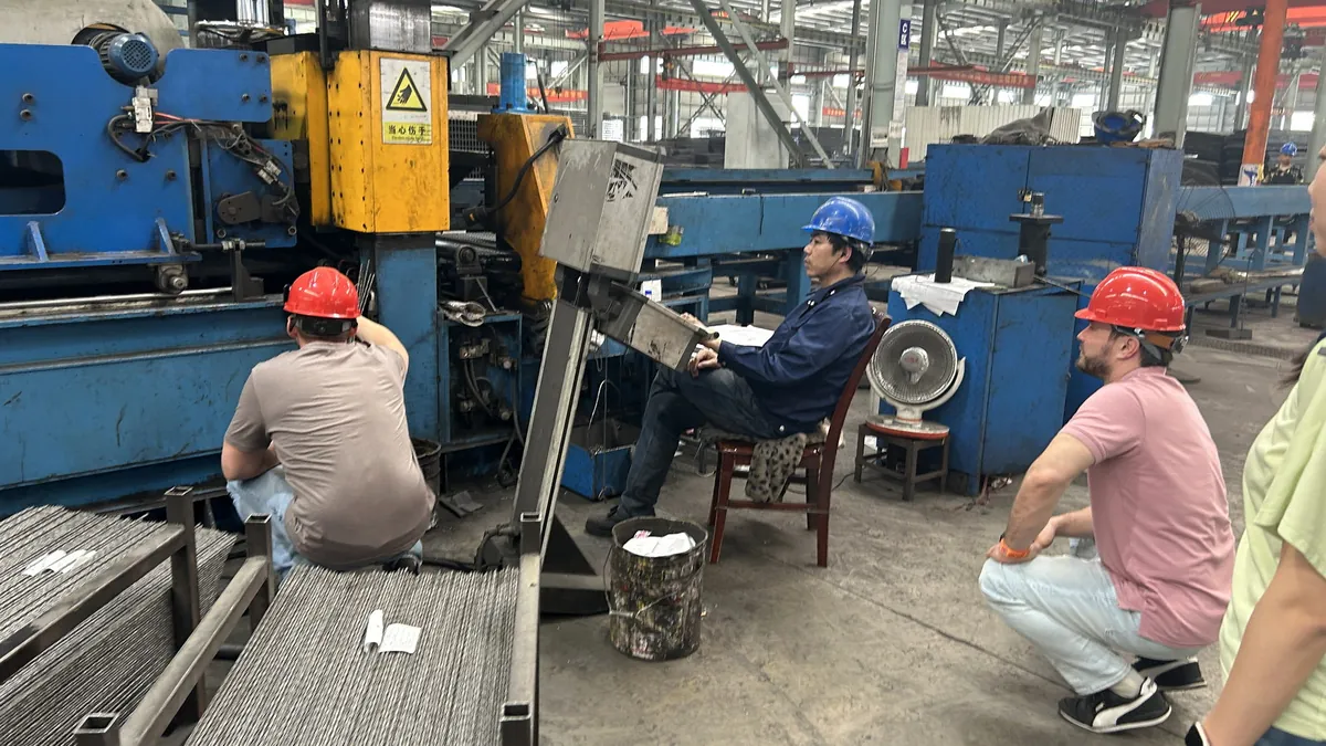 After-sales engineers commissioning welding equipment with a customer team